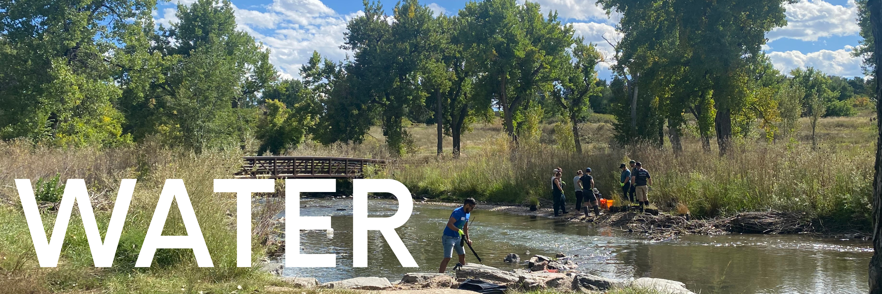 Image of Bear Creek with volunteers along the banks. Overlaid is text that says "Water"